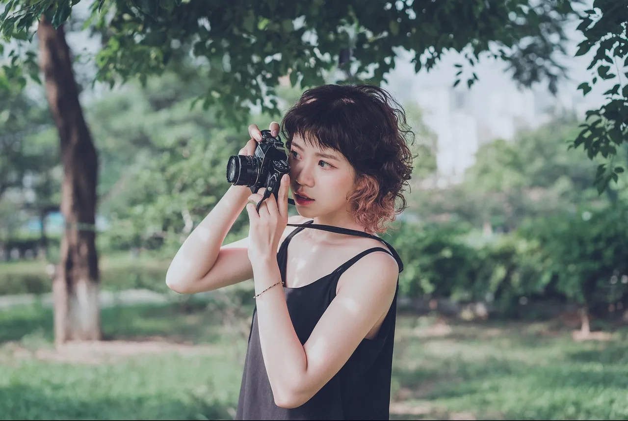 woman, camera, photographer, tool, nature, equipment, trees, leaves, foliage. Planning a fictional community portrait project with layered consent case