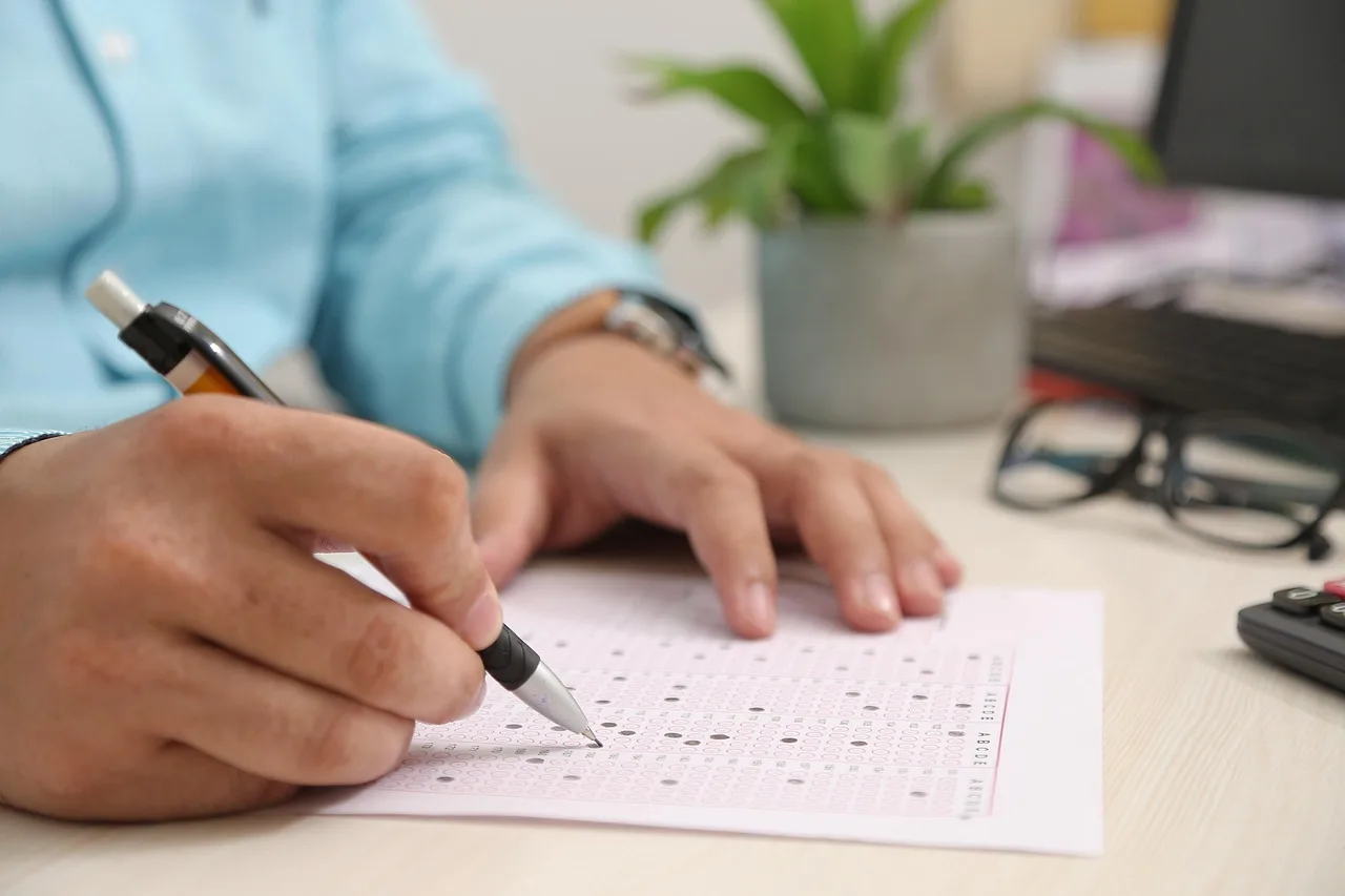 test paper, answering, hand, note, filling sheet, filling form, test paper, test paper, test paper, test paper, test paper. Image consent problems: vague permission, changed context and indefinite reuse