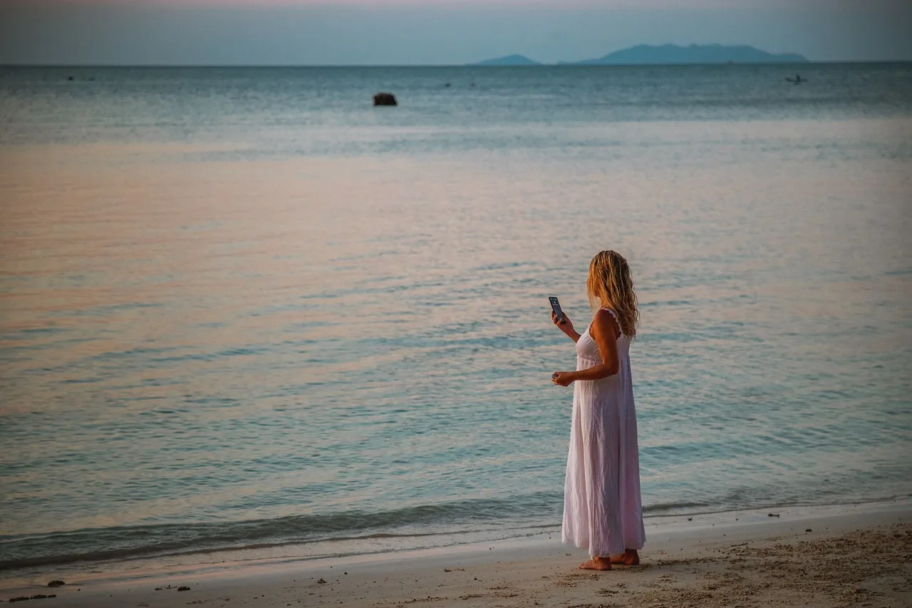 wait for a call, taking photos, woman, blond, beach, water, sunset, photography, nature, camera, smartphone, photo, mobile, female, people, to travel, person, phone, lifestyle, picture, wait, reception, cell phone reception. What Section 230 means for Americans whose photos are reposted